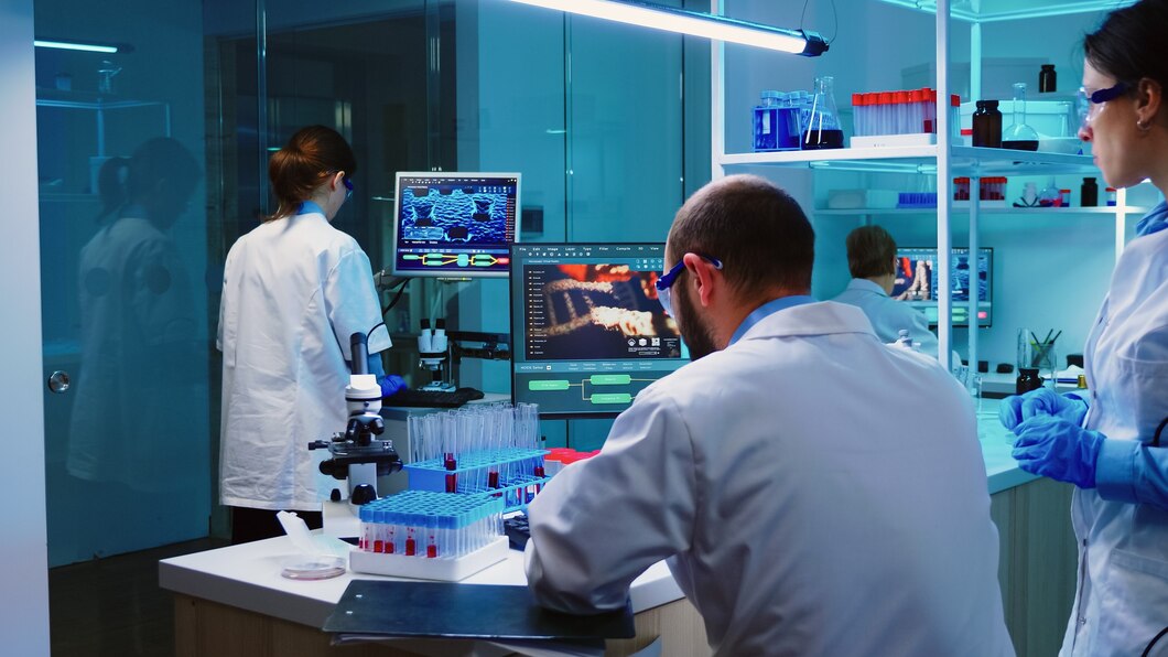 Scientist examining research data on computer screens in a modern laboratory setting, representing clinical biotin research